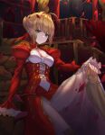  1girl ahoge blonde_hair blurry breasts cleavage corset fate/extra fate/grand_order fate_(series) flower green_eyes hair_flower hair_ornament highres looking_at_viewer nero_claudius_(fate)_(all) ocean petals saber_extra short_hair smile solo 