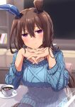  1girl admire_vega_(umamusume) animal_ears bangs blush brown_hair cup hand_on_own_face highres horse_ears horse_girl indoors jewelry long_hair looking_at_viewer necklace pink_eyes plate sitting smile solo spoon starheart sweater table umamusume very_long_hair 