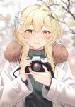  1girl blonde_hair blue_nails blurry blurry_background blurry_foreground blush branch camera closed_mouth commentary eyebrows_visible_through_hair flower fur_trim genshin_impact green_sweater hair_between_eyes hair_flower hair_ornament highres holding holding_camera jacket kul_(ngsensei) leaf long_sleeves looking_at_viewer lumine_(genshin_impact) outdoors sidelocks smile solo sweater upper_body white_jacket yellow_eyes 