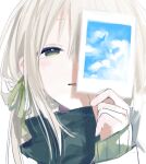  1girl blonde_hair blush clouds face green_eyes green_ribbon hair_ribbon half-closed_eyes holding holding_picture long_hair original parted_lips picture_(object) qidius ribbon signature simple_background sleeves_past_wrists smile solo upper_body white_background 