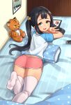  1girl ajidot andvari_(last_origin) ass bangs black_hair bow dolphin_shorts from_behind green_eyes hair_bow highres last_origin long_hair looking_at_viewer looking_back lying on_bed on_stomach open_mouth short_shorts shorts smile solo stuffed_animal stuffed_tiger stuffed_toy tablet_pc thigh-highs twintails v white_legwear 