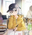  absurdres bangs baseball_cap black_eyes cafe cellphone copyright_request earrings glasses hat highres indoors jacket jewelry looking_at_viewer mole mole_under_eye phone silver_hair sitting smartphone sora_zz6 table twitter_username yellow_jacket 