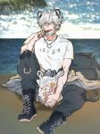  1boy animal_ears arknights artist_name bag bags_under_eyes bandaid bandaid_on_hand beach bear_boy bear_ears bishounen boots eating food grey_eyes highres jaye_(arknights) jewelry male_focus necklace otenjou ring_necklace scar shirt short_hair silver_hair sitting sleepy solo tired watermark white_shirt 