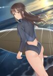  1girl ass bangs bodysuit brown_hair closed_mouth commentary_request dutch_angle eyebrows_visible_through_hair from_behind highres holding holding_surfboard kitazawa_(embers) long_hair long_sleeves looking_at_viewer looking_back original solo sun sunset surfboard swimsuit water wetsuit wind yellow_eyes 