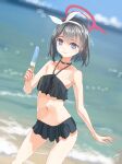  1girl absurdres bangs beach bikini black_bikini black_hair blue_archive blurry bokeh bow bow_hairband cowboy_shot dated depth_of_field dutch_angle food frilled_bikini frills hairband halo highres holding holding_food light_blush light_smile looking_at_viewer mashiro_(blue_archive) midriff navel no_wings outdoors popsicle short_hair signature solo swimsuit utachy violet_eyes water white_bow white_hairband 