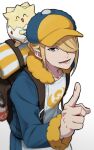  1boy backpack bag bangs blonde_hair blue_jumpsuit blurry brown_bag eyelashes fur_trim hair_bun hair_over_one_eye hand_up hat index_finger_raised jumpsuit looking_at_viewer lower_teeth male_focus open_mouth pokemon pokemon_(creature) pokemon_(game) pokemon_legends:_arceus pokemon_on_back short_hair smile teeth togepi tongue volo_(pokemon) yellow_headwear yoko.u 