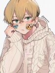  1boy bangs blonde_hair brown_sweater closed_mouth earrings green_eyes hair_between_eyes head_rest highres jewelry long_sleeves looking_at_viewer male_focus matsuno_chifuyu poyan_08 short_hair simple_background single_earring sleeves_past_wrists solo sticker sweater tokyo_revengers twitter_username undercut upper_body white_background 