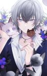  1boy animal animal_on_head blue_eyes candy cat close-up ear_piercing food hair_between_eyes highres holding holding_food looking_at_viewer muon on_head original piercing siamese_cat solo symbol-only_commentary watch watch white_hair 