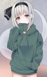  1girl absurdres alternate_costume bangs black_hairband black_ribbon blue_eyes blush breasts closed_mouth commentary_request eyebrows_visible_through_hair floor ghost green_hoodie grey_hair hairband hand_in_pocket hand_up highres hitodama hood hoodie konpaku_youmu konpaku_youmu_(ghost) long_sleeves looking_at_viewer medium_breasts no_pants puffy_long_sleeves puffy_sleeves ribbon short_hair solo standing stigma1101 touhou wall 