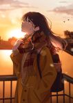  1girl absurdres bangs blurry blurry_background brown_coat brown_eyes brown_hair coat dusk earphones floating_hair hair_between_eyes hand_in_pocket highres lens_flare long_hair long_sleeves looking_up mele_ck open_clothes open_coat original outdoors parted_lips scarf solo standing straight_hair winter_clothes winter_coat 