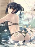  1girl arm_rest ass back bangs bare_shoulders bikini black_bikini black_hair breasts bush cherry_blossoms closed_mouth flower from_behind hair_between_eyes highres kantai_collection kasumi_(skchkko) lamp large_breasts looking_at_viewer looking_back nagato_(kancolle) oil-paper_umbrella onsen outdoors petals petals_on_liquid red_eyes smile solo swimsuit tied_hair tree umbrella water wet 
