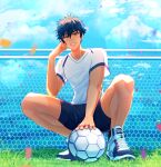  1boy absurdres ball black_shorts blurry clouds confetti depth_of_field ensemble_stars! fence grass hand_on_own_face highres lens_flare looking_at_viewer male_focus nemesis0903 net orange_eyes outdoors sazanami_jun shirt shoes shorts sky sneakers soccer soccer_ball solo squatting sweatdrop white_footwear white_shirt 