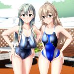  2girls absurdres beach_umbrella blue_swimsuit breasts clothes_writing competition_swimsuit cowboy_shot fence green_eyes grey_swimsuit hair_ornament hairclip hands_on_hips highres kantai_collection kumano_(kancolle) large_breasts leaning_forward long_hair looking_at_viewer multicolored_clothes multicolored_swimsuit multiple_girls one-piece_swimsuit silver_hair suzuya_(kancolle) swimsuit table takafumi umbrella 