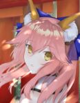  1girl animal_ear_fluff animal_ears bangs blue_bow blurry blurry_background blurry_foreground bow commentary day detached_collar english_commentary eyebrows_visible_through_hair eyelashes face fate/extra fate_(series) fox_ears fox_girl hair_between_eyes hair_bow highres lips long_hair looking_at_viewer looking_back minako_larima new_year outdoors pink_hair sidelocks solo split_ponytail tamamo_(fate) tamamo_no_mae_(fate/extra) teeth torii yellow_eyes 