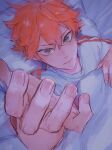  1boy 830_(hamio) bed bed_sheet brown_eyes haikyuu!! hair_between_eyes highres hinata_shouyou looking_at_viewer lying male_focus messy_hair on_back orange_hair pillow reaching_out shirt solo white_shirt 