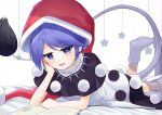 1girl absurdres arm_support bangs bed black_dress blue_eyes blue_hair book doremy_sweet dress eyebrows_visible_through_hair hand_on_own_cheek hand_on_own_face hat highres looking_at_viewer multicolored_clothes multicolored_dress negi_0712 open_mouth pom_pom_(clothes) red_headwear short_hair sleeveless solo tail tapir_tail touhou white_dress 