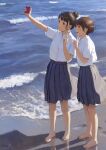  2girls bangs barefoot beach black_hair blue_skirt brown_eyes brown_hair commentary full_body grin hair_bun highres holding holding_phone multiple_girls ocean open_mouth original papi_(papiron100) parted_bangs phone pleated_skirt school_uniform selfie shirt short_hair signature skirt smile white_shirt 