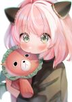  1girl animal_ears anya_(spy_x_family) bangs black_shirt blurry blush depth_of_field green_eyes highres holding looking_at_viewer medium_hair pink_hair rojineco_nene shirt simple_background soft_focus solo spy_x_family stuffed_animal stuffed_toy white_background 