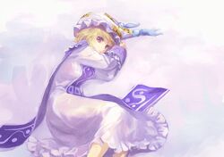  1girl blonde_hair dress frills hat highres light_smile long_sleeves looking_at_viewer lying multiple_tails no_tail nyonsuke pillow_hat short_hair solo tabard tail tassel touhou violet_eyes white_dress wide_sleeves yakumo_ran 