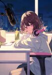  1girl absurdres bangs black_shorts bottle brown_hair chair city_lights cityscape closed_mouth cover_image from_side gaming_chair head_rest headphones headphones_around_neck highres hood hood_down hoodie indoors koi_wa_yozora_wo_watatte long_sleeves looking_at_viewer looking_to_the_side microphone night official_art on_chair short_hair shorts shugao sitting smile solo table textless_version violet_eyes white_hoodie 