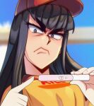  1girl angry arwald bangs baseball_cap black_hair blue_eyes blurry blurry_background burger_king employee_uniform frown furrowed_brow hat highres hime_cut holding implied_pregnancy kiryuuin_satsuki long_hair looking_at_viewer pointing portrait pregnancy_test red_headwear shirt sidelocks solo symbol-only_commentary thick_eyebrows uniform v-shaped_eyebrows yellow_shirt 