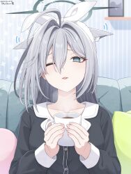  1girl ;< ;p ahoge animal_ear_fluff animal_ears artist_name black_shirt blue_archive blue_eyes cat's_tongue collarbone commentary couch cup dated ears_down extra_ears grey_hair hair_between_eyes halo highres holding holding_cup hot_chocolate indoors k-d long_hair long_sleeves looking_at_viewer mug one_eye_closed pillow shiroko_terror_(blue_archive) shirt solo straight-on tearing_up tongue tongue_out upper_body wince wolf_ears 