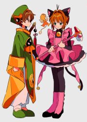  1boy 1girl animal_ear_fluff animal_ears antenna_hair apron bell black_dress black_pantyhose blush boots brown_eyes brown_hair cardcaptor_sakura cat_ears cat_girl cat_tail closed_mouth commentary_request dress full_body fuuin_no_tsue green_eyes green_hat green_shirt green_shoes hat holding holding_wand kero_(cardcaptor_sakura) kinomoto_sakura kinomoto_sakura_(kitty) li_syaoran long_sleeves neck_bell pants pantyhose pink_apron pink_boots sanamaru_(sana79261827) shirt shoes short_hair simple_background standing tail wand white_pants 
