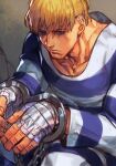  1boy bandaged_hand bandages blonde_hair blue_eyes chain closed_mouth cody_travers cuffs facial_hair hand_wraps handcuffs hankuri male_focus prison_clothes serious sitting solo street_fighter stubble 