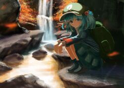  1girl absurdres backpack bag blue_eyes blue_hair blush boots cattail flat_cap front_ponytail green_bag green_hat hair_bobbles hair_ornament hat highres kawashiro_nitori leaf looking_at_viewer lunati_no maple_leaf plant rock rubber_boots shirt short_hair skirt solo squatting tokin_hat touhou twintails two_side_up water waterfall wrench 
