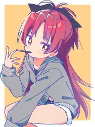  1girl absurdres black_bow blue_shorts blush border bow bright_pupils closed_mouth commentary dot_nose feet_out_of_frame food food_in_mouth fur-trimmed_shorts fur_trim grey_hoodie hair_bow hand_up highres hood hood_down hoodie long_hair long_sleeves looking_at_viewer mahou_shoujo_madoka_magica mahou_shoujo_madoka_magica_(anime) navel outside_border parted_bangs pocky pocky_in_mouth red_eyes red_hair ruru_(rurumagi) sakura_kyoko short_shorts shorts simple_background sitting solo white_border white_pupils yellow_background 