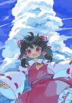  1girl :d ascot bangs black_hair blue_sky bow clouds cowboy_shot detached_sleeves frilled_skirt frills from_below hair_bow hair_tubes hakurei_reimu highres kibisake looking_at_viewer medium_hair open_mouth outdoors red_bow red_eyes red_shirt red_skirt ribbon-trimmed_sleeves ribbon_trim shirt skirt sky smile solo standing touhou wide_sleeves yellow_ascot 