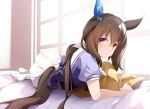  1girl admire_vega_(umamusume) animal_ears bed brown_hair commentary_request hair_between_eyes hair_ornament horse_ears horse_tail long_hair lying mofu_namako pillow ponytail school_uniform solo tail thigh-highs tracen_school_uniform umamusume violet_eyes 