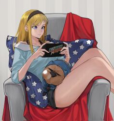  1girl bare_shoulders black_hairband black_shorts blonde_hair blue_eyes blue_shirt capybara chair closed_mouth collarbone commentary commission copyright_logo copyright_name corrupted_twitter_file english_commentary feet_out_of_frame hairband handheld_game_console highres holding holding_handheld_game_console kamen_america kamen_america_(comic) kobi420 light_smile lips logo long_hair nose on_chair on_pillow shirt shorts sidelocks sitting solo squeans thighs 