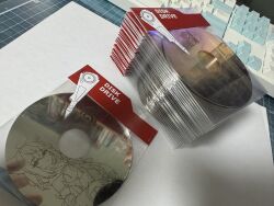  1girl ahoge animal_ears bookey comiket commentary_request double-parted_bangs fox_ears hair_between_eyes hard_drive highres laser_engraving_(medium) light_frown looking_at_viewer low_ponytail monochrome navel neckerchief photo_(medium) ponytail shirakami_fubuki shirakami_fubuki_(1st_costume) short_shorts shorts solo spot_color strapless unconventional_media upper_body vest wide_sleeves 