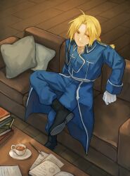  1boy absurdres ahoge aka_(pixiv111240176) amestris_military_uniform black_boots book boots braid cafe couch edward_elric figure_four_sitting fullmetal_alchemist gloves highres indoors long_sleeves looking_at_viewer military_uniform on_couch open_book pillow short_hair sitting solo white_gloves 