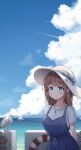  1girl arms_behind_back beach bird blue_dress blue_eyes blush boat bow breasts brown_hair chami_(pixiv15867443) closed_mouth clouds cloudy_sky commentary contrail dappled_sunlight day dress english_text fence hat hat_bow hat_ribbon highres jewelry lifebuoy looking_at_viewer medium_breasts necklace ocean original outdoors ribbon sailboat scenery seagull shirt shirt_under_dress short_sleeves sky smile solo standing sun_hat sunlight upper_body watercraft white_shirt 