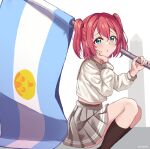  1girl absurdres argentinian_flag bangs chestnut_mouth commentary_request flag green_eyes grey_sailor_collar grey_skirt hair_between_eyes hand_on_own_face hand_up highres holding holding_flag kurosawa_ruby light_blush linatai long_sleeves looking_at_viewer love_live! love_live!_sunshine!! mixed-language_commentary pleated_skirt redhead sailor_collar school_uniform shirt skirt socks solo spanish_commentary squatting twintails twitter_username uranohoshi_school_uniform white_background white_shirt 