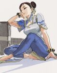  1girl blue_leggings bracelet brown_eyes brown_hair chest_cutout china_dress chinese_clothes chun-li double_bun dress earrings elbow_on_table eyelashes hair_bun hair_pulled_back highres jewelry leggings looking_away masso short_sleeves sitting solo street_fighter street_fighter_6 