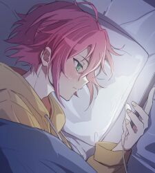 1boy closed_mouth commentary drawstring ensemble_stars! fingernails green_eyes hair_between_eyes highres holding holding_phone hood isara_mao long_sleeves lying male_focus on_side phone pillow red_hair reijiro short_hair solo 