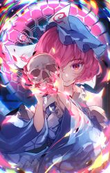  1girl asa_no_ha_(pattern) blue_hat blue_kimono blue_ribbon breasts chiroru_(cheese-roll) chromatic_aberration commentary commentary_request hat highres holding holding_skull japanese_clothes kimono large_breasts long_sleeves looking_at_viewer mob_cap neck_ribbon petal_print pink_eyes pink_hair print_kimono ribbon saigyouji_yuyuko skull sleeve_garter smile solo touhou triangular_headpiece wide_sleeves 