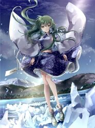  1girl blue_skirt closed_mouth commentary_request detached_sleeves frog_hair_ornament gohei green_eyes green_hair hair_ornament hair_tubes highres holding holding_gohei kochiya_sanae long_hair looking_at_viewer nanop38 outdoors single_hair_tube skirt smile snake_hair_ornament solo touhou water 