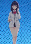  1girl bare_legs black_hair blue_eyes blue_sky bow bowtie chain-link_fence commentary contrail day earphones fence gridman_universe hand_in_pocket highres long_hair long_sleeves looking_at_viewer outdoors scrunchie shigatsu_(4gate) sky solo ssss.gridman standing takarada_rikka wrist_scrunchie 