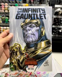  1boy armor art_tools_in_frame artist's_hand_in_frame clenched_hand colored_skin commentary cover_sketch english_commentary gold_armor helmet highres infinity_gauntlet male_focus marker_(medium) marvel photo_(medium) purple_skin signature solo stanley_lau thanos traditional_media 