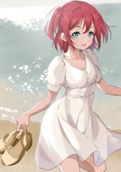  1girl aqua_eyes beach breasts commentary dress empire_waist from_above gorilla-shi hair_between_eyes highres holding_unworn_shoes kurosawa_ruby looking_at_viewer love_live! love_live!_sunshine!! ocean open_mouth red_hair short_dress short_hair short_sleeves small_breasts solo sundress two_side_up white_dress 