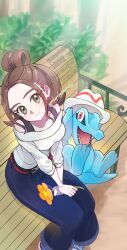  1girl absurdres artist_name bell-bottoms belt bench blue_pants blue_shoes brown_eyes brown_hair commentary_request crocodile crocodilian flower harmony_(pokemon) hat highres holding long_sleeves looking_at_viewer looking_up lumiose_city on_bench pants park park_bench petals pokemon pokemon_(creature) pokemon_legends:_z-a pokepokekonpeki shirt shoes short_hair smile striped_hat totodile trilby white_hat white_shirt yellow_flower 