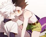  2boys bare_shoulders black_hair blue_eyes boy_on_top brown_eyes child commentary_request face-to-face gon_freecss green_shorts highres hunter_x_hunter killua_zoldyck male_child male_focus multiple_boys open_mouth shirt short_hair shorts spiky_hair tank_top turtleneck white_hair white_shirt white_tank_top yomi4310 