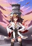  1girl absurdres ahoge battlecruiser boots brown_hair cannon clouds day detached_sleeves double_bun frilled_skirt frills hair_bun hairband hands_on_hips headgear highres japanese_clothes kantai_collection kongou_(battleship) kongou_(kancolle) kongou_kai_ni_(kancolle) long_hair military military_vehicle nontraditional_miko outdoors ribbon-trimmed_sleeves ribbon_trim ship skirt sky solo standing thigh_boots turret user_wgvw4555 violet_eyes warship watercraft 