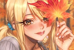  1girl autumn autumn_leaves blonde_hair blue_scrunchie blurry blurry_background blush brown_eyes commentary english_commentary eris21471224 eyelashes fairy_tail fingernails grey_sweater hair_ornament hair_scrunchie highres holding holding_leaf leaf lips long_hair looking_at_viewer lucy_heartfilia maple_leaf outdoors pink_lips portrait scrunchie sidelocks signature solo sweater tree twintails upper_body 