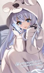  1girl animal_hood bed blue_eyes blue_hair braid cellphone commission etoria highres holding holding_phone hood long_hair onesie open_mouth phone project_nebula second-party_source sitting skeb_commission solo usui_yura virtual_youtuber 