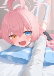  1girl absurdres ahoge black_skirt blue_archive blue_eyes blue_socks collared_shirt commentary fang feet_up hair_between_eyes halo heterochromia highres hoshino_(blue_archive) long_hair long_sleeves looking_at_viewer lying no_shoes on_bed on_stomach open_mouth orange_eyes pink_hair pink_halo plaid_clothes plaid_skirt pleated_skirt rihitonn shirt skirt smile socks solo white_shirt 